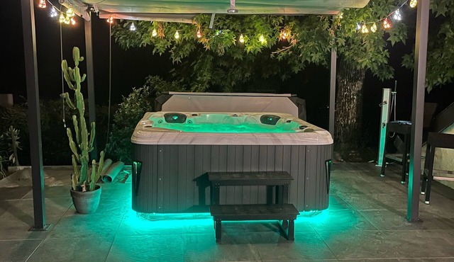 House with a hot tub, lake views, and lake access