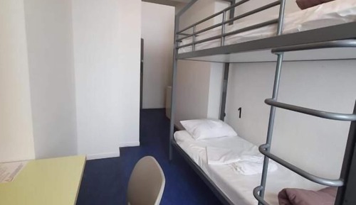 Room with 2 bunk beds and bathroom